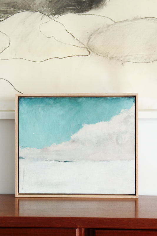 Turquoise cloud on white horizon