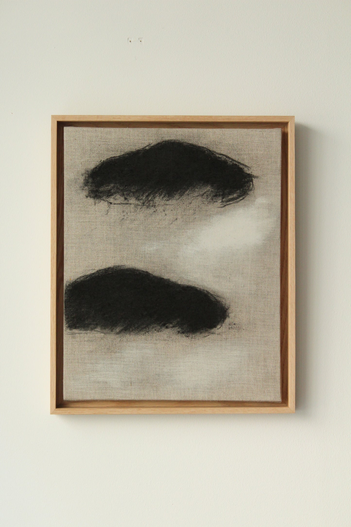 Two black clouds on linen