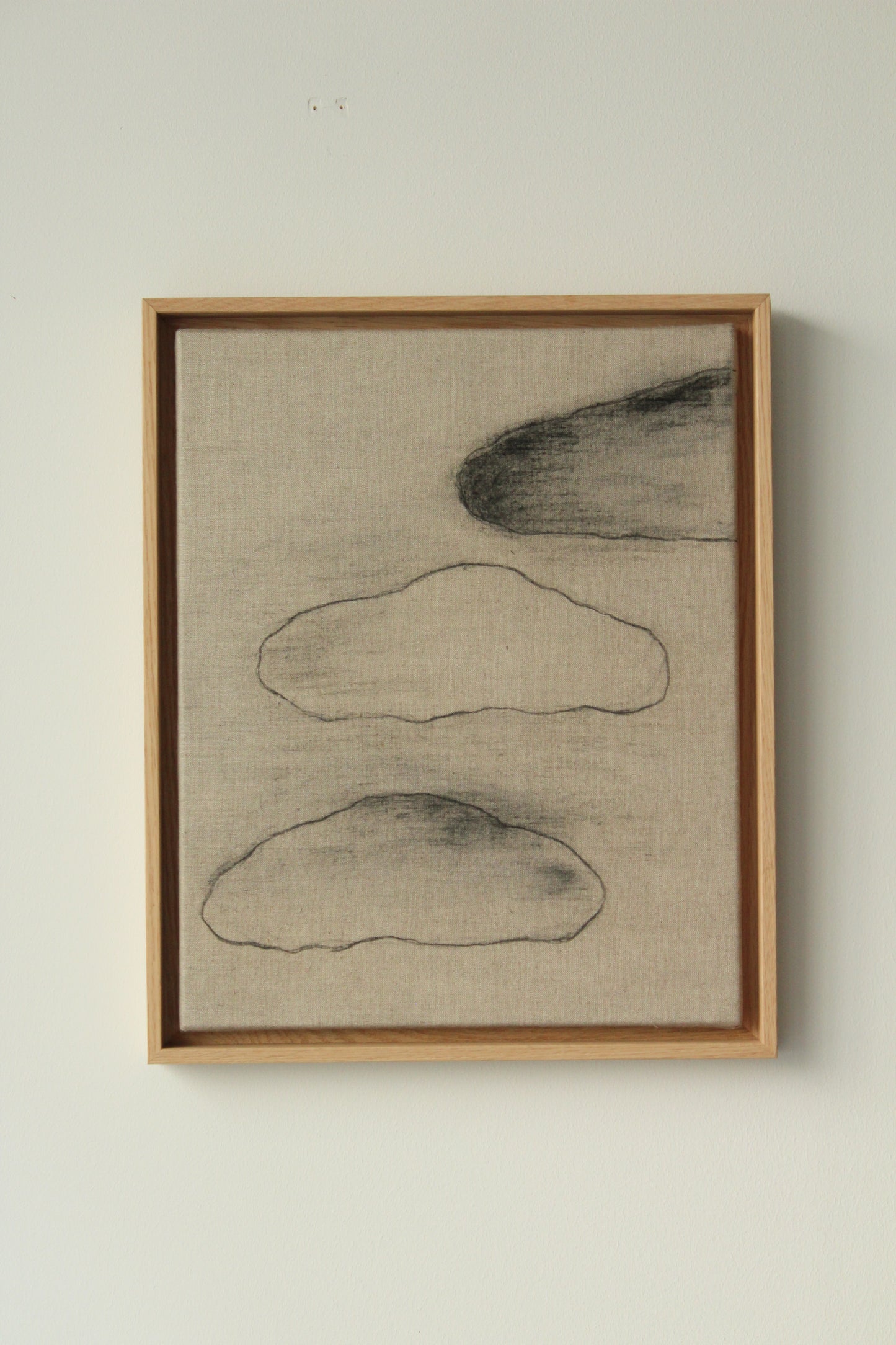 Three black clouds on linen