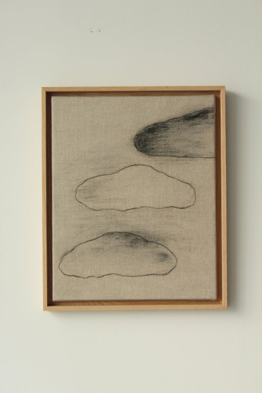 Three black clouds on linen