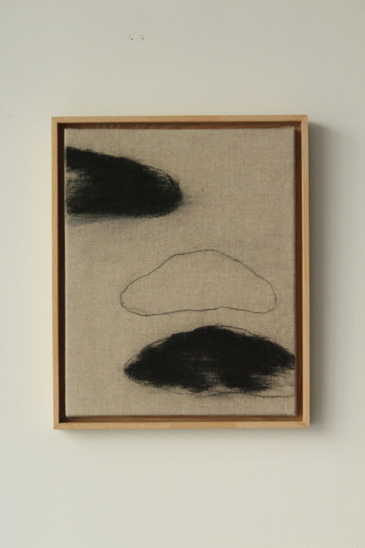 Three black clouds on linen